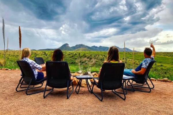 Four people sitting and drinking wine in the Arizona wine country