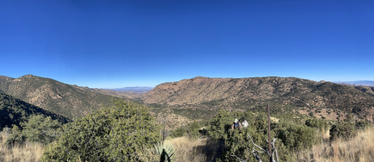 Two people hiking with blue skies in southern Arizona